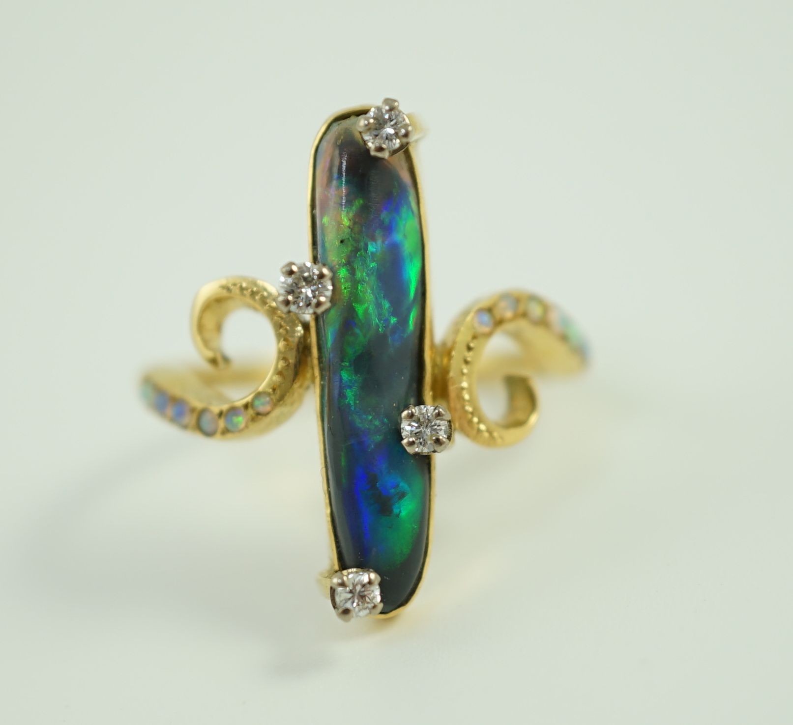 A stylish early to mid 20th century 18ct gold, black opal and diamond chip set dress ring